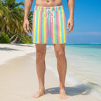 Pastel striped shorts worn by a person on a tropical island beach
