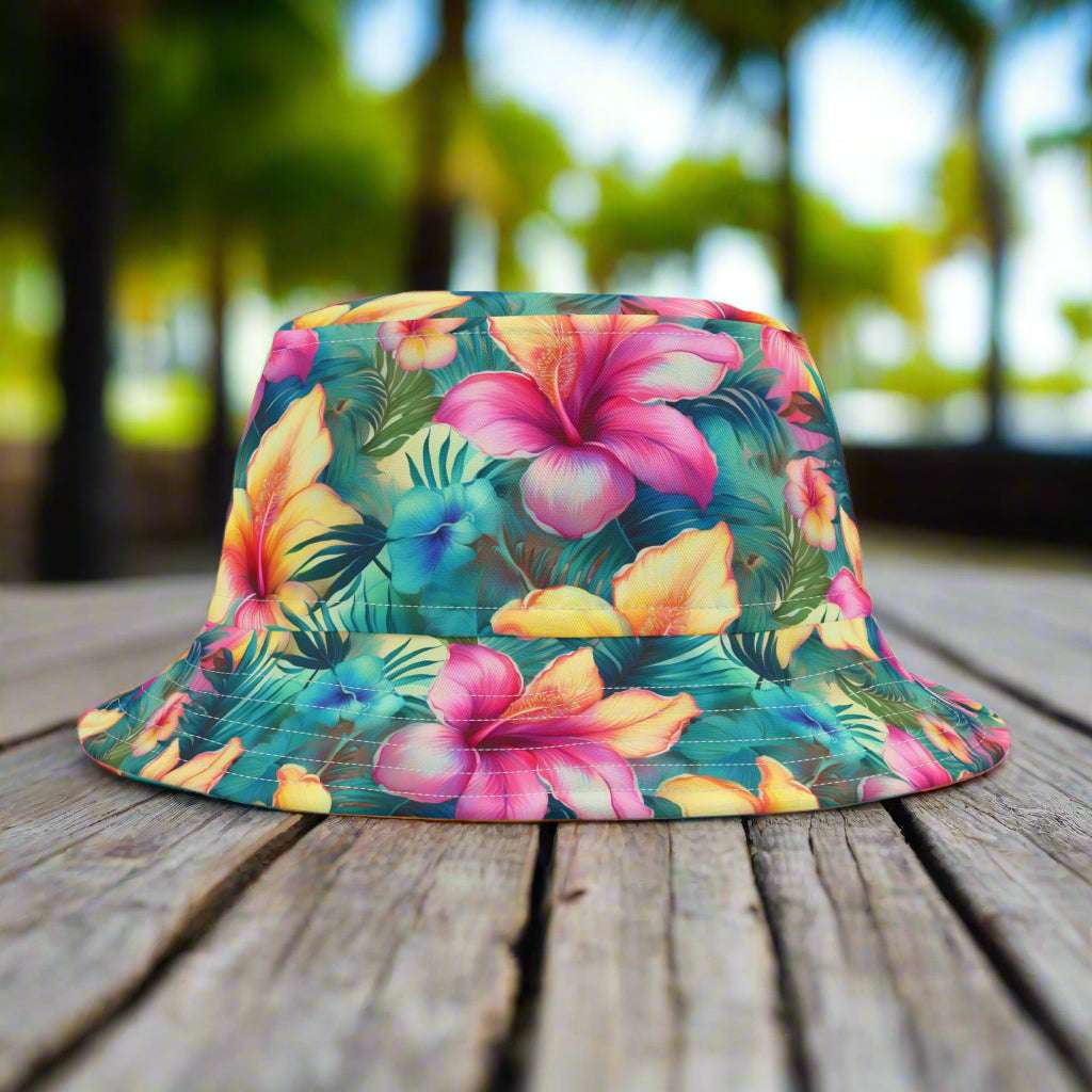Bucket hat with beautiful tropical floral pattern sitting on a rustic wood park table in a park in Key West