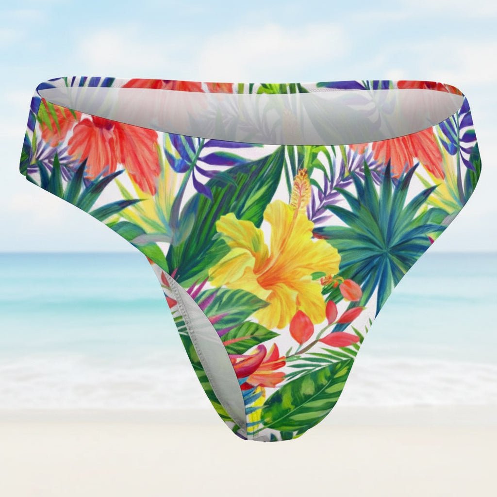 Tropical floral patterned swim briefs on a faded beach background