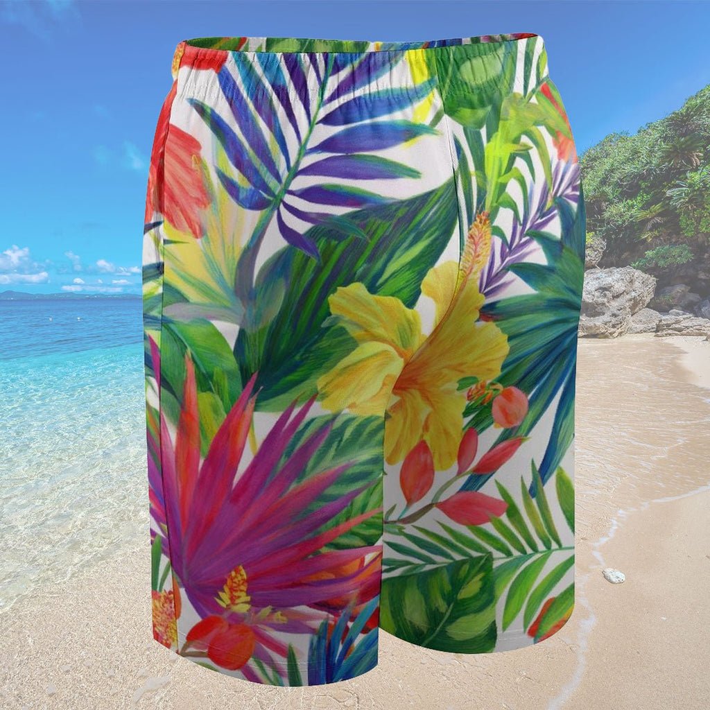Colorful tropical leaf patterned shorts on a beach background
