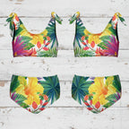 Font and back tropical print kid's bikini set on a rustic nautical wood background