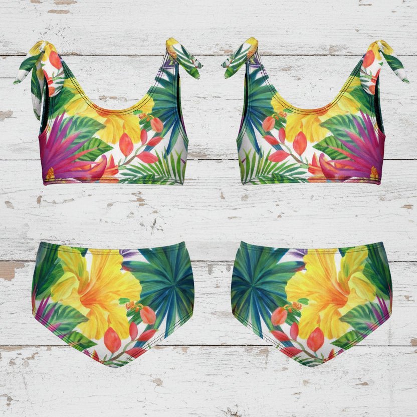 Font and back tropical print kid's bikini set on a rustic nautical wood background
