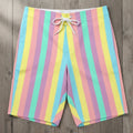 Tropical Pastel striped board shorts on a rustic wood background
