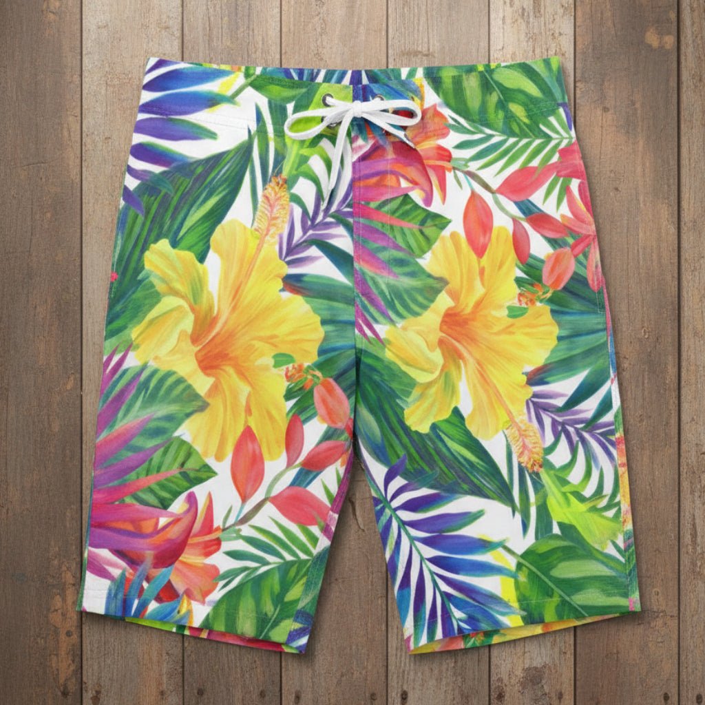 Colorful tropical floral shorts laying flat on nautical wood background 