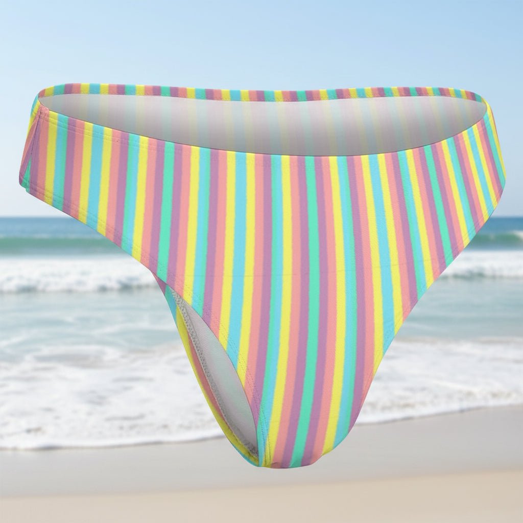 Multicolored striped bikini bottom on a faded beach background