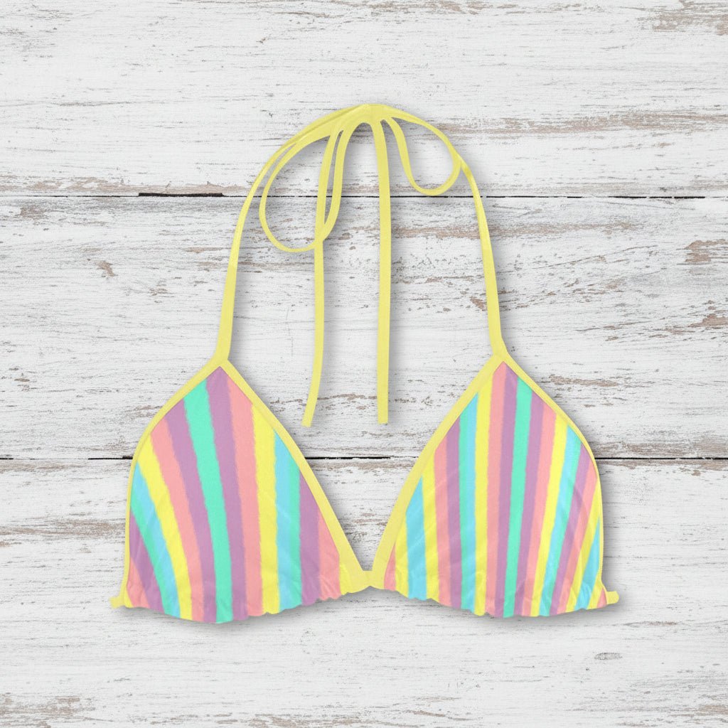 Pastel striped bikini top on a nautical wood background