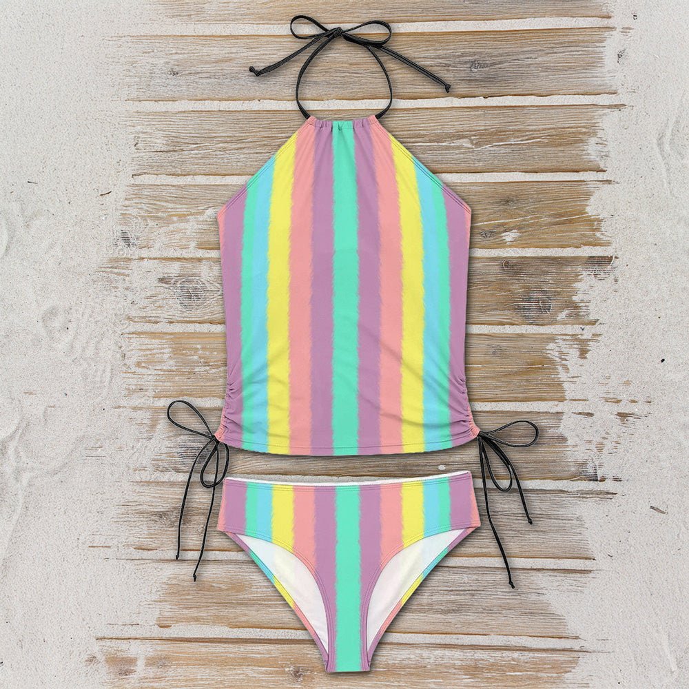 Pastel striped bikini set on a wooden surface