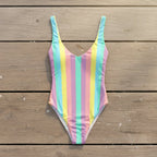 Multicolored striped swimsuit on a rustic wood deck