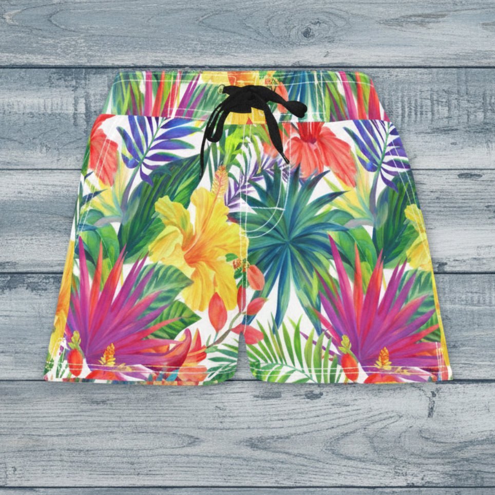 Colorful tropical leaf patterned shorts on a wooden surface