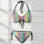 Multicolored striped bikini set on a white  Nautical wood background