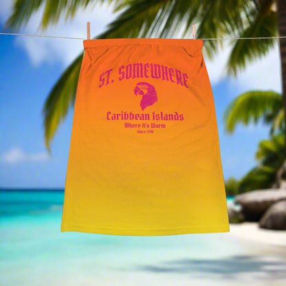Orange to yellow gradient crop top with text and logo hanging on a line in a tropical island paradise