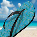 Flip-flop with dolphin pattern in team colors on a blue background at the beach