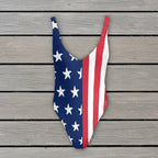 One-piece swimsuit with American flag design on a rustic nautical wood  background