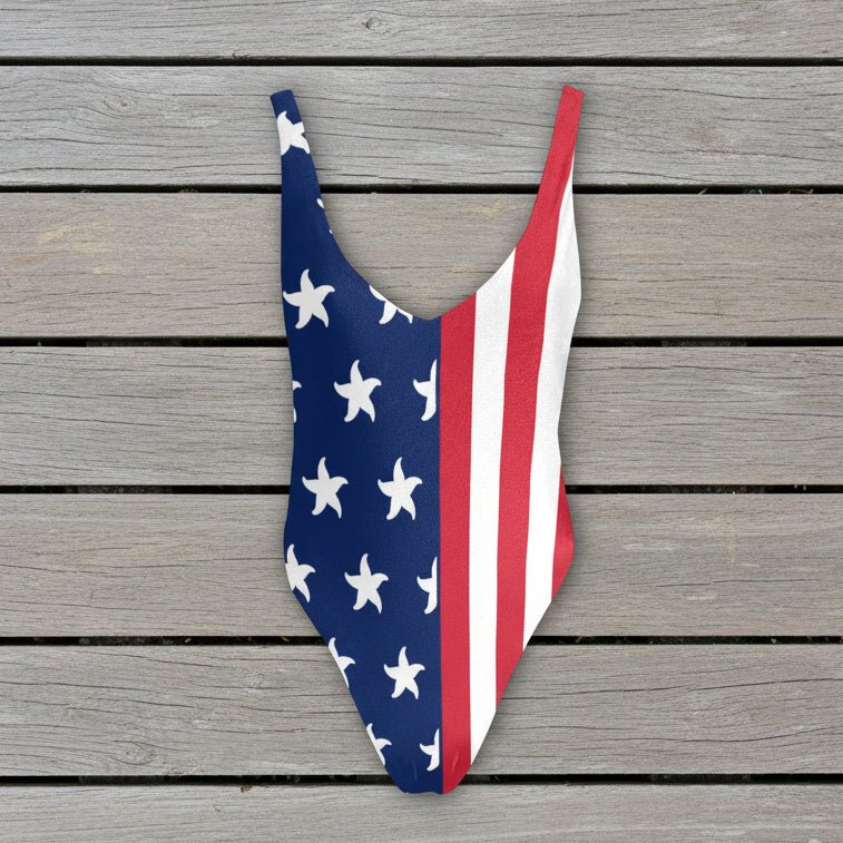 One-piece swimsuit with American flag design on a rustic nautical wood  background