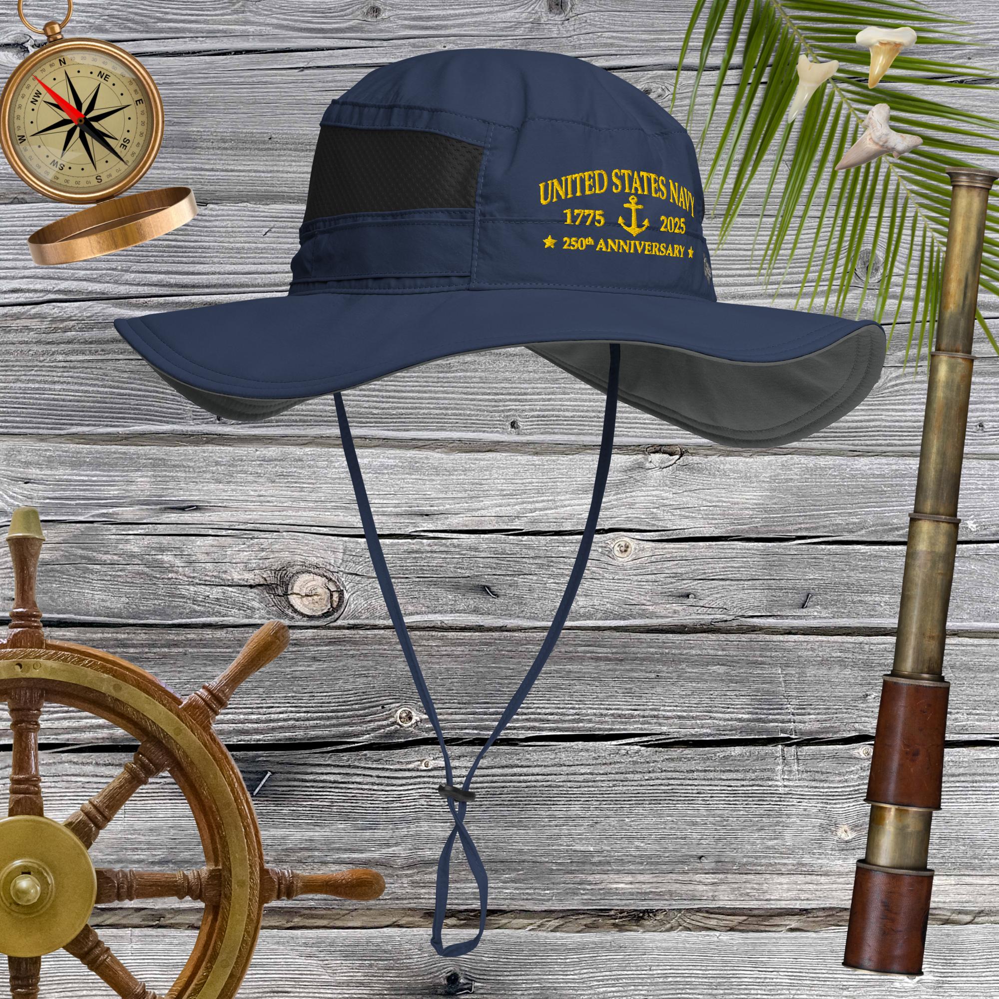 Navy blue hat with yellow text on a wooden background with nautical items.