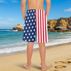 Teen youth standing on La Jolla Beach in Stars & Stripes Board Shorts