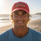 Red cap with US 2.5 text and American flag design on a on La Jolla Beach