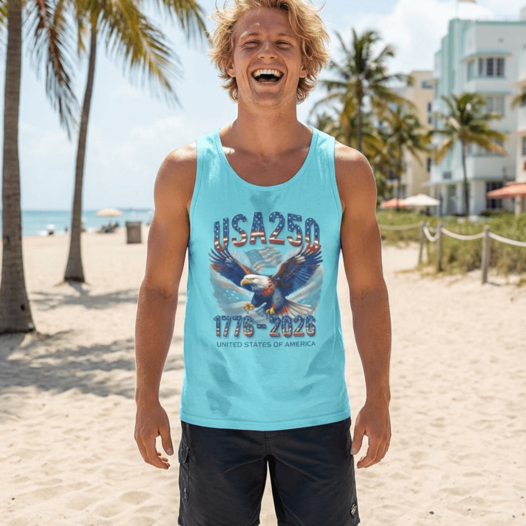 Man wearing a blue American Anniversary Tank Top with an eagle design on a beach