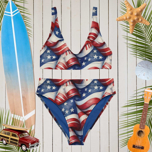 American flag swimsuit on a wooden background with beach elements.