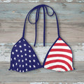 Bikini top with American flag design on a rustic wood background
