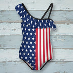 One-piece swimsuit with American flag design on a rustic nautical wood background