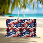 Oversized tote back featuring USA flag pattern sitting on a beach in a tropical paradise