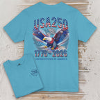 Teal t-shirt with eagle and 'USA 250' design on a wooden surface