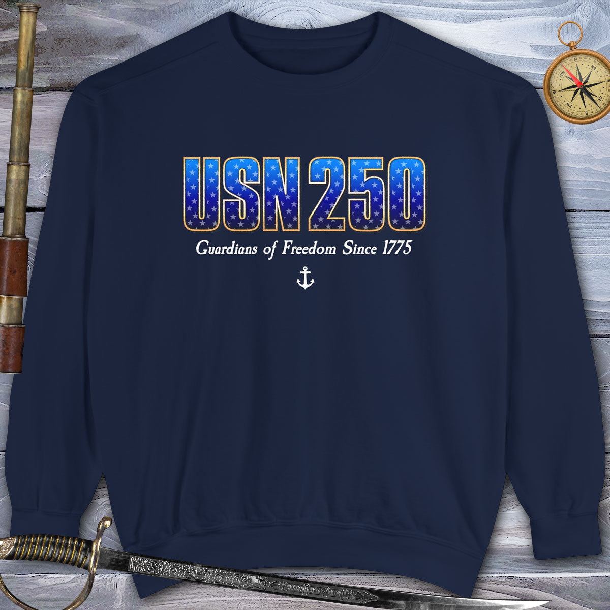 Navy blue sweatshirt with 'USN 250' text on a wooden background