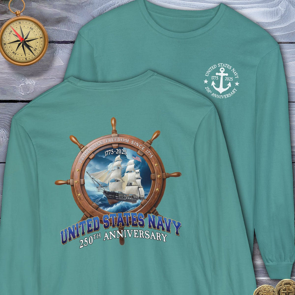 Two teal long-sleeve shirts with United States Navy 250th Anniversary designs on a wooden surface.