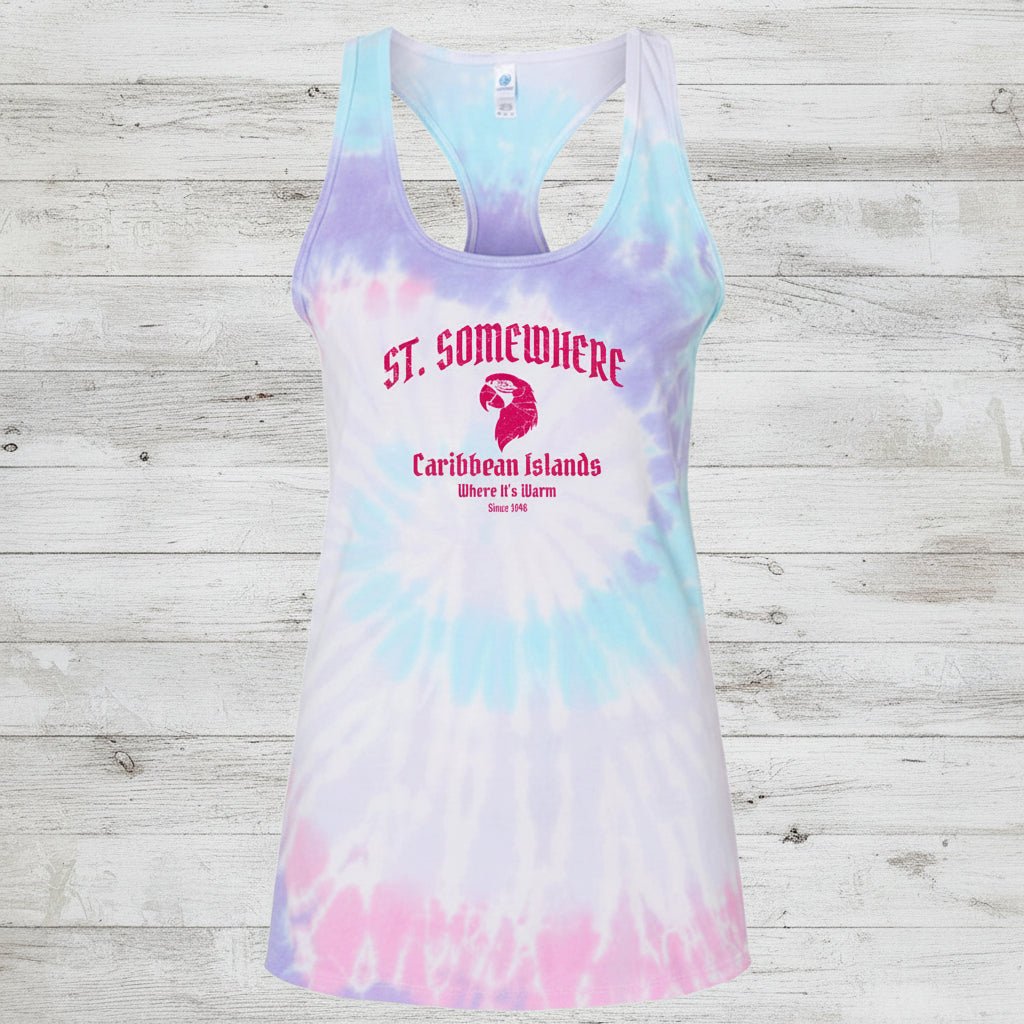 A racerback tank top with a pastel tie-dye pattern in purple, blue, and pink, featuring a red graphic print on the front that reads 'ST. SOMEBWHERE Caribbean Islands Where It's Hot'.