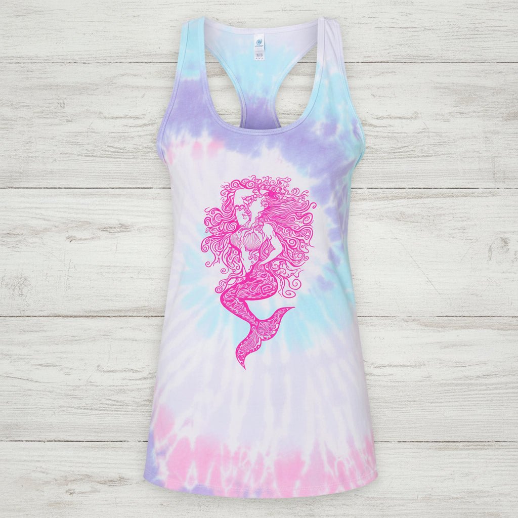 A women's racerback tank top featuring a pastel tie-dye pattern in pink, purple, and blue, with a prominent pink mermaid graphic printed on the front.