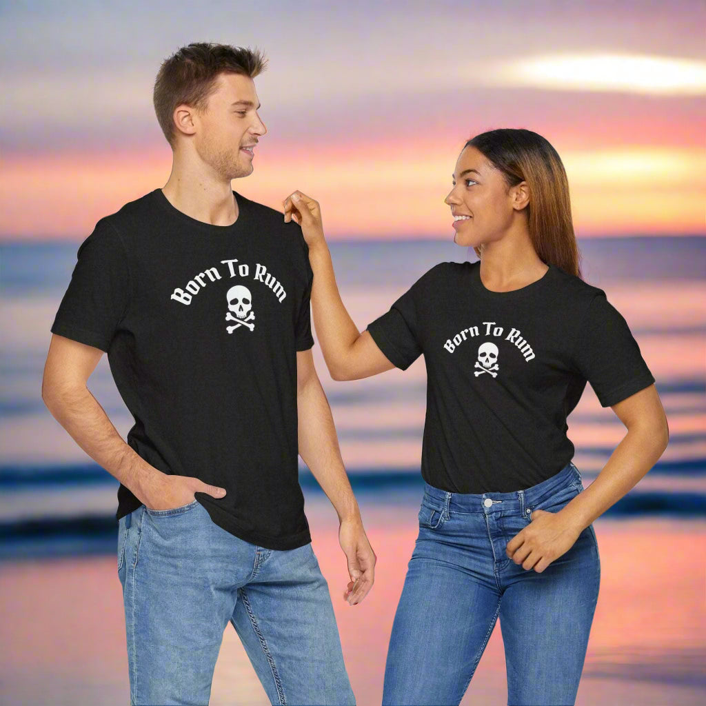 Born to Rum Jolly Roger Pirate Skull T-Shirt, worn by a couple standing on a beach at sunset
