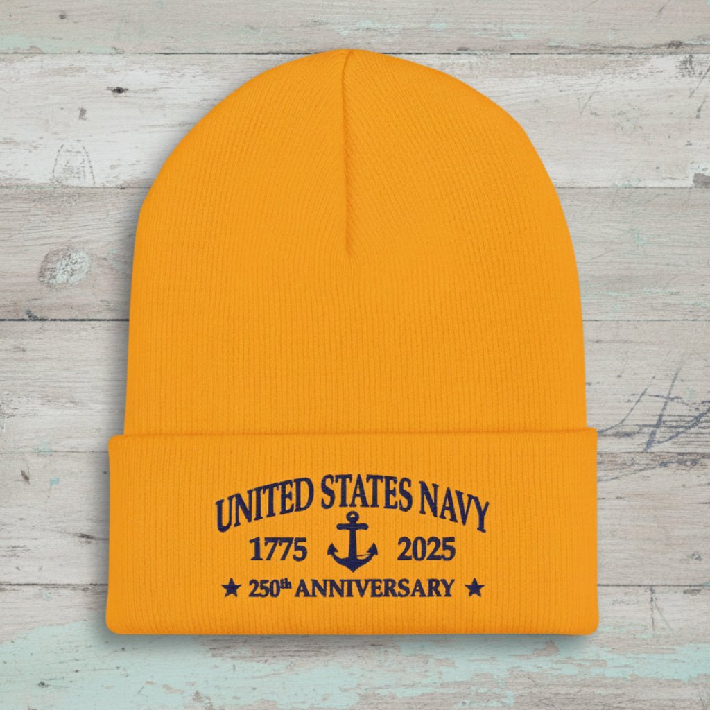 A bright gold ribbed knit Navy Anniversary beanie hat with a folded cuff featuring navy blue embroidered text that reads 'UNITED STATES NAVY 1775 2025 250th ANNIVERSARY' with an anchor in the center.