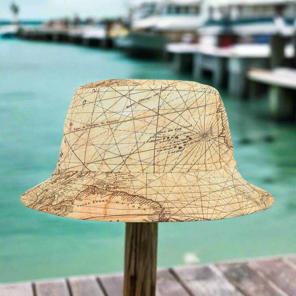 Vintage Nautical Chart Bucket Hat sitting on a pier railing in a marina in Key West