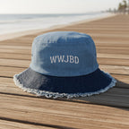 Blue bucket hat with WWJBD (what would Jimmy Buffett Do?) sitting on a beachside boardwalk