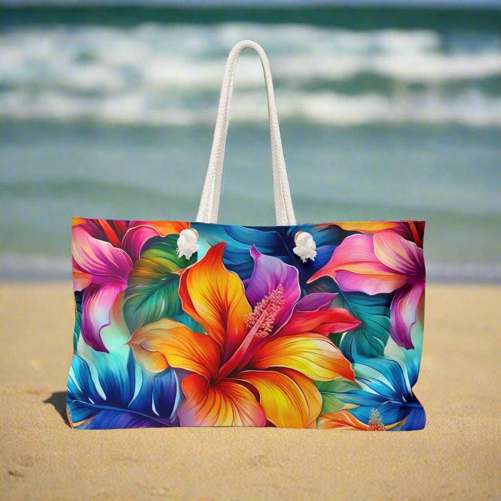 Oversized tote bag with Hawaiian style flowers sitting on the beach in Waikiki