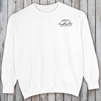 White sweatshirt with text on a wooden surface
