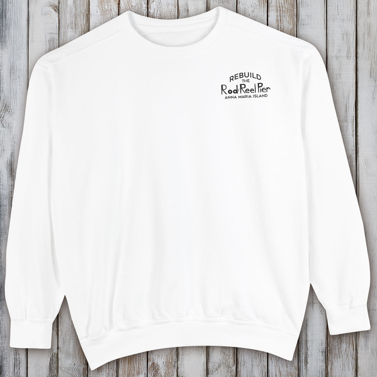 White sweatshirt with text on a wooden surface