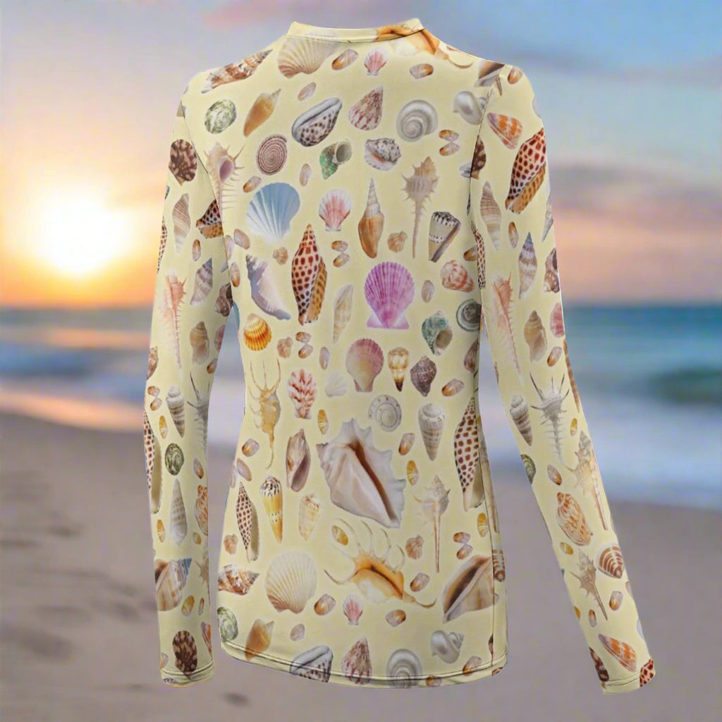 Long-sleeve shirt with shell pattern floating over a beach at sunrise 