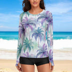 Woman wearing a long-sleeve sun shirt with palm tree pattern on a beach