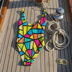 Colorful geometric patterned swimsuit on the deck of a vintage sailboat