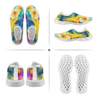 A four-panel product collage showing tropical floral slip-on shoes from multiple angles: top, side, back, and sole views. The shoes have a bright multicolor print with yellow, blue, green, purple, and pink flowers and leaves, plus thick white soles and white footbeds.