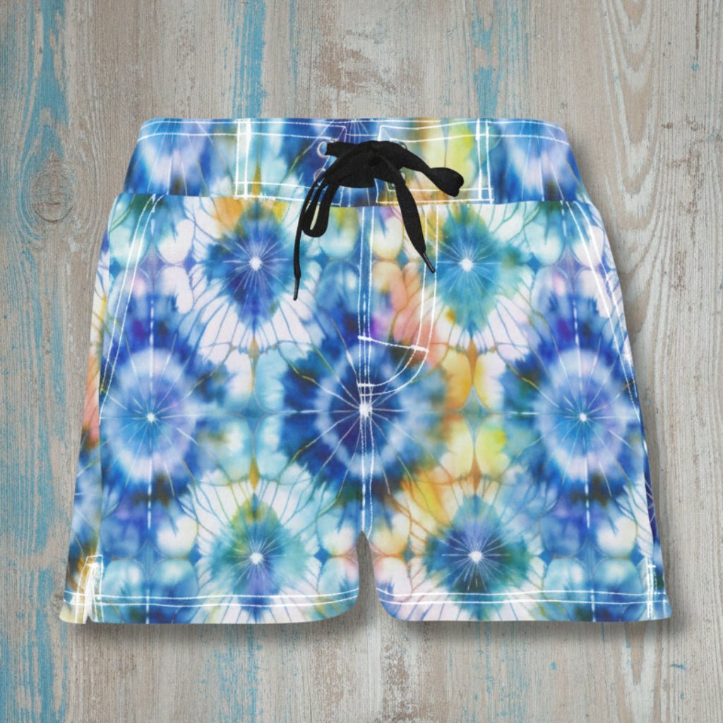 Colorful tie-dye shorts on a wooden surface