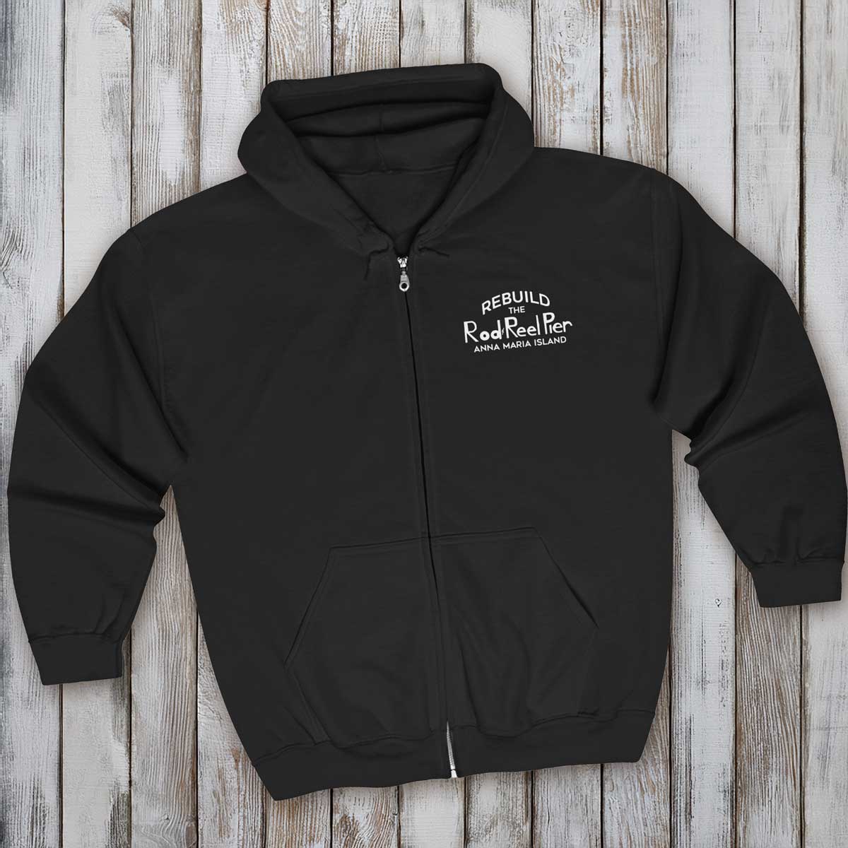 Black hoodie with a logo on a wooden surface