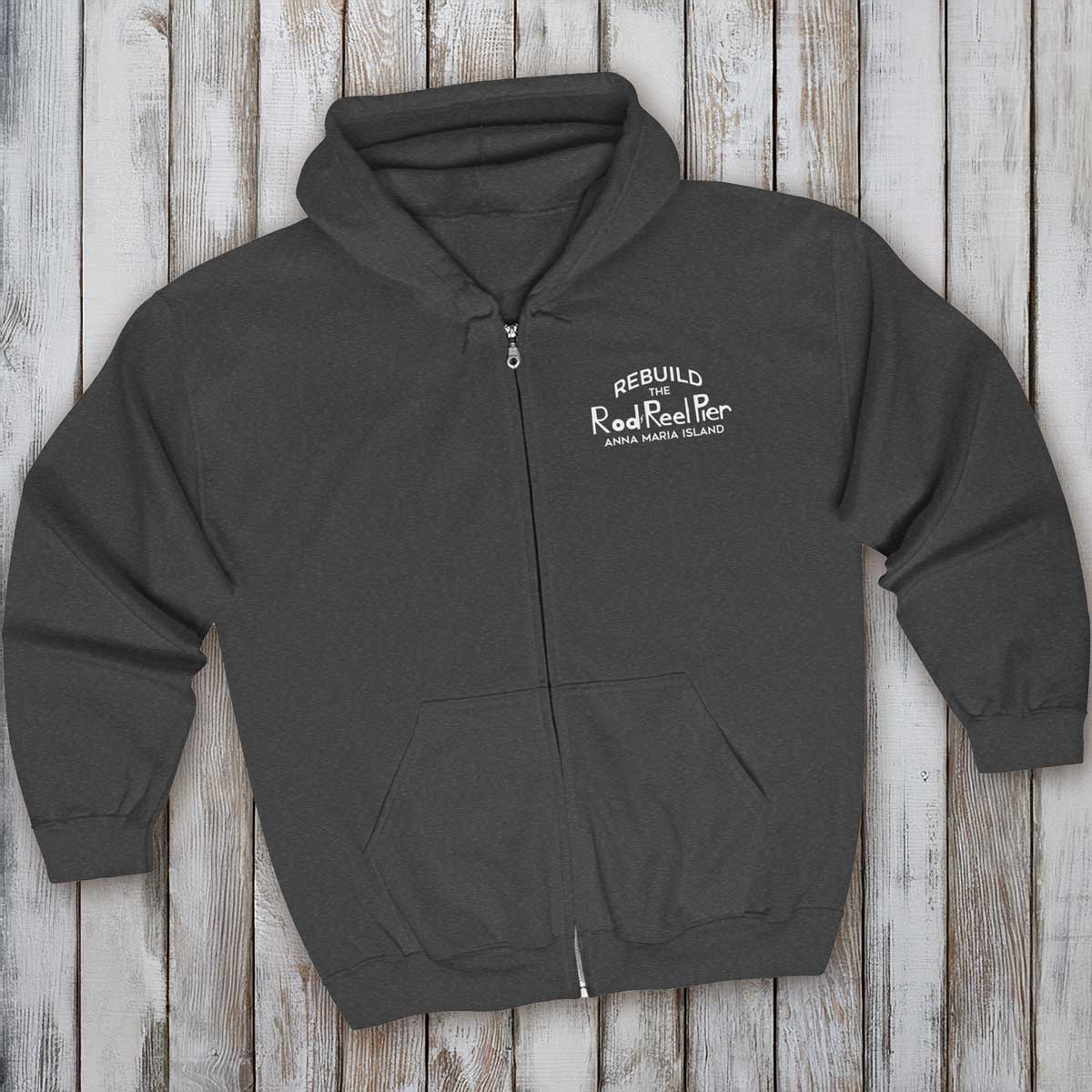 Dark gray hoodie with text on a wooden surface