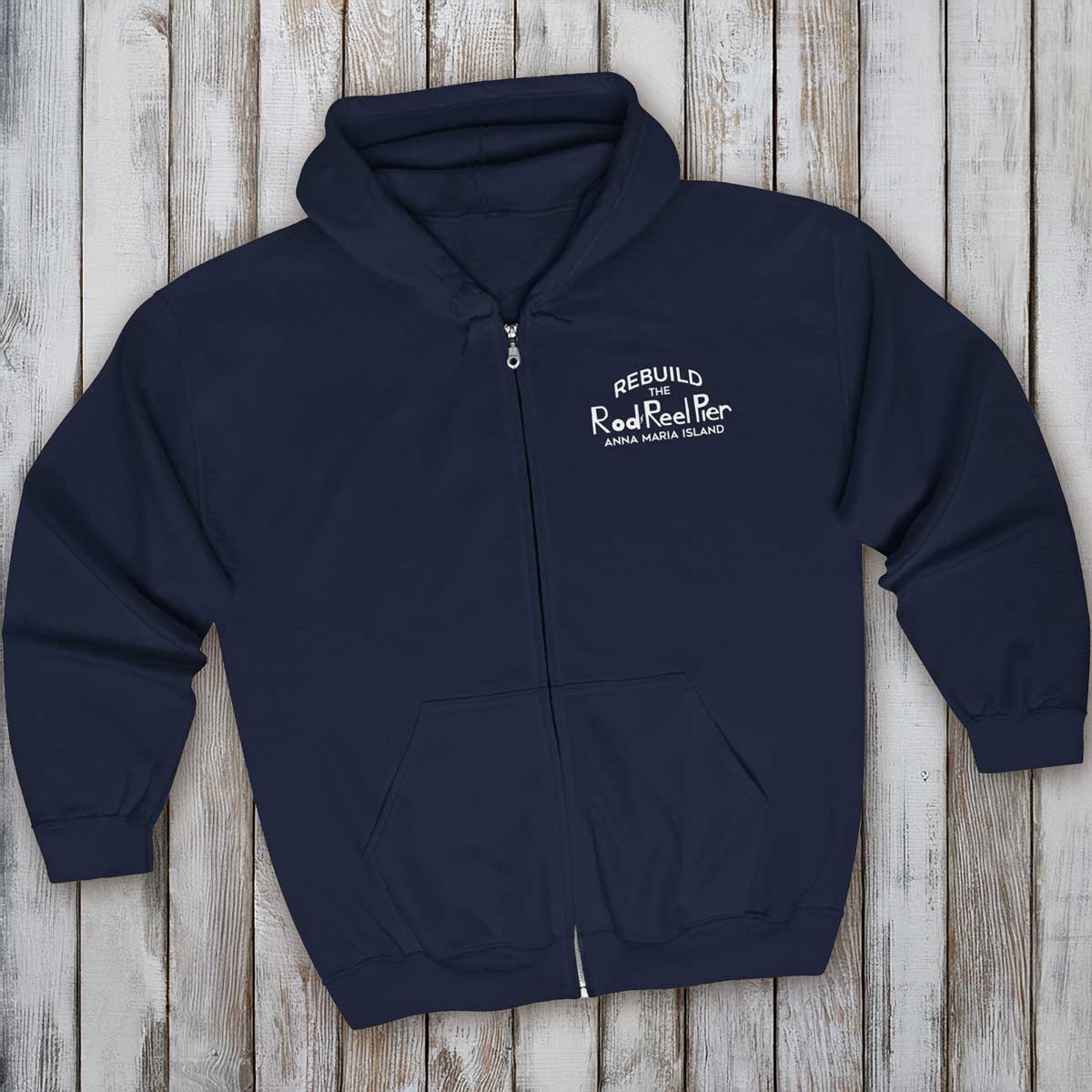 Navy blue hoodie with text on a wooden surface
