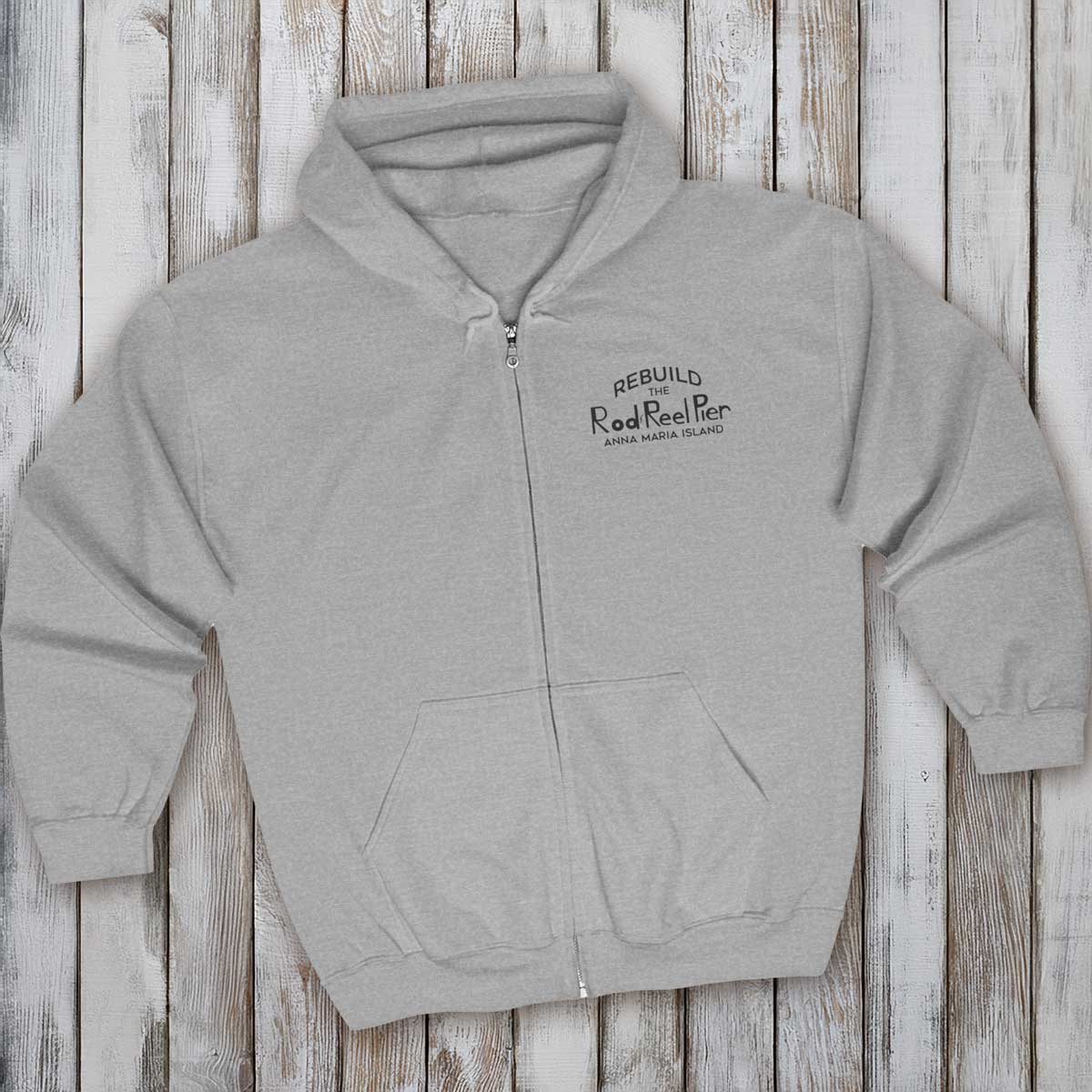 Gray hoodie with text on a wooden surface