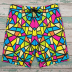 Colorful geometric patterned shorts laying flat on rustic nautical wood