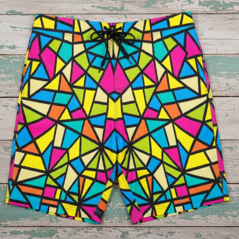 Colorful geometric patterned shorts laying flat on rustic nautical wood
