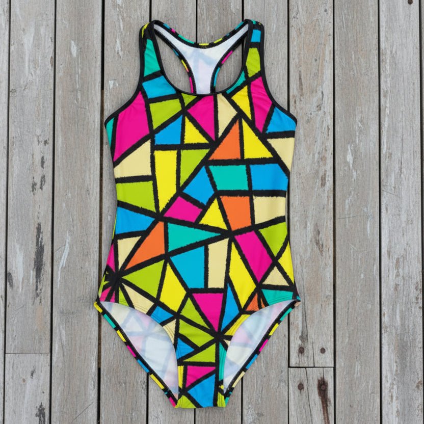Multicolored geometric patterned swimsuit on a rustic nautical wood background